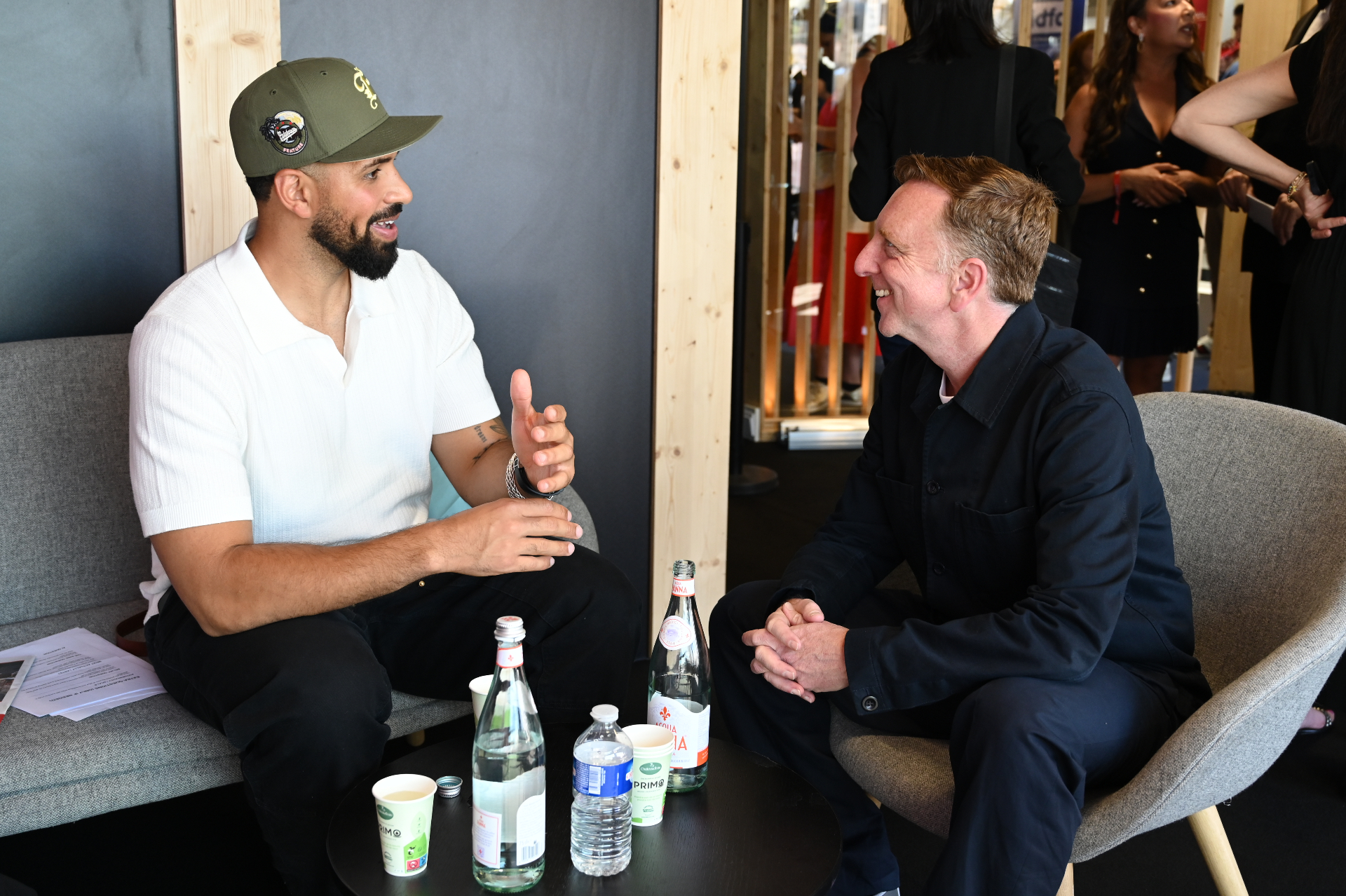 Tyler Sabino and a guest deep in conversation at the Marché du Film lounge on the Croisette during Cannes Film Festival 2026