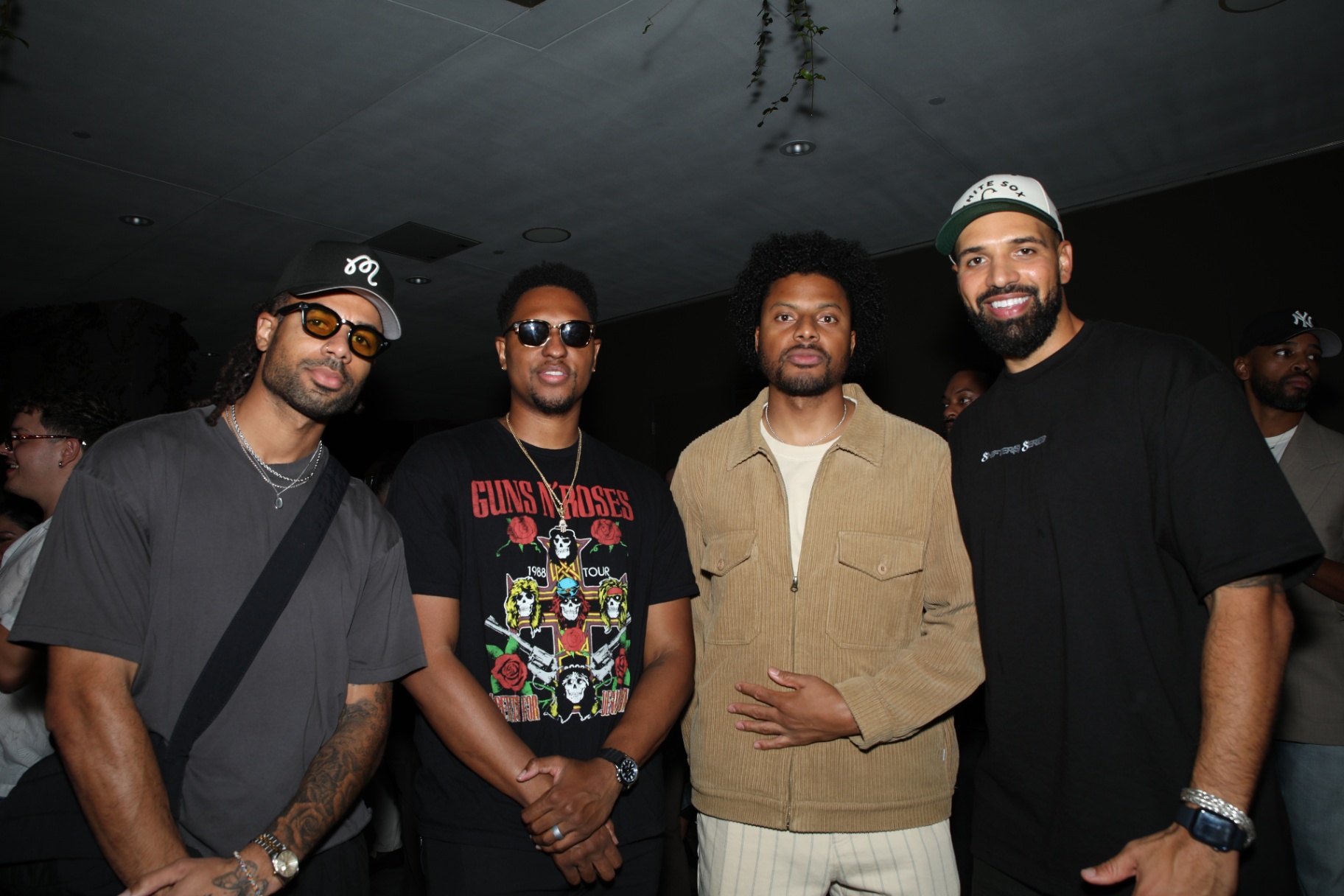 A group of guests posing together at the Rhythm Garden after party